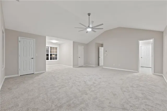 a view of an empty room with a ceiling fan