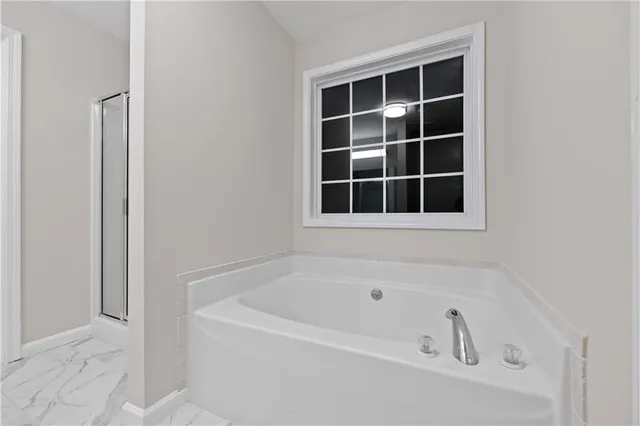 a white bath tub sitting next to a window