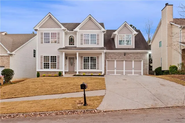 a front view of a house with garden