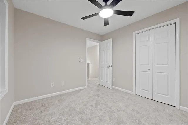 an empty room with chandelier fan