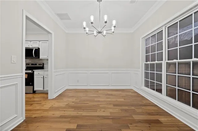 a view of a kitchen with wooden floor and a ceiling fan