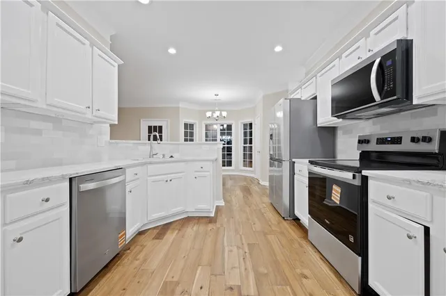 a kitchen with a sink microwave and cabinets