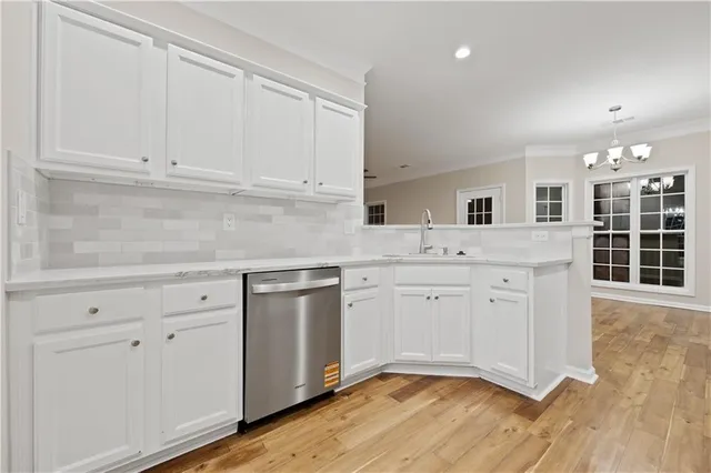 a kitchen with granite countertop white cabinets and white appliances