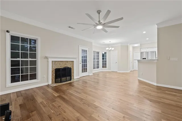 a view of an empty room with a window and fireplace