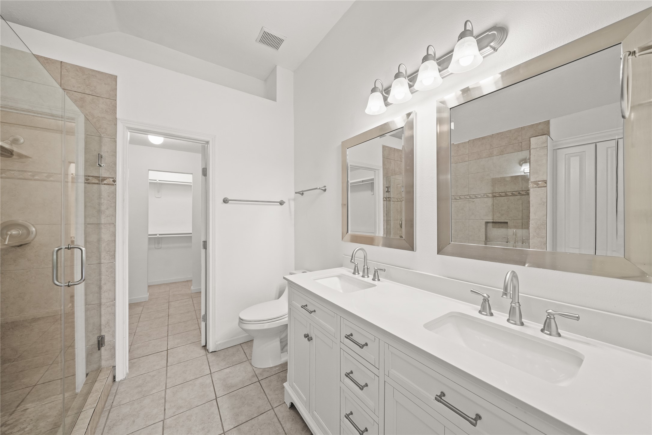 8134 Blue Jay Street Baytown, TX 77523 - Photo 22 of 31 The primary bathroom showcases an expansive dual vanity with double sinks, thoughtfully designed to provide both convenience and a refined sense of space.