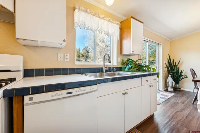 a kitchen with a sink and large window