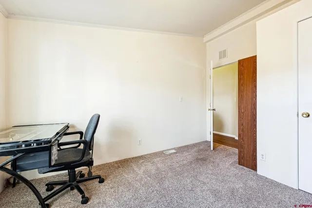 a view of a workspace with furniture