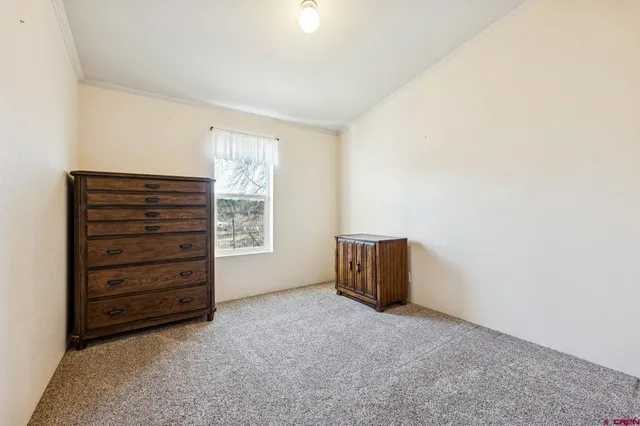 a view of room with furniture and a dresser