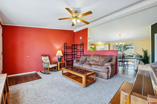 a living room with furniture pool table and a large window