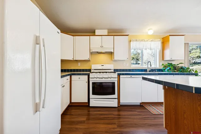 a kitchen with stainless steel appliances a stove and a refrigerator