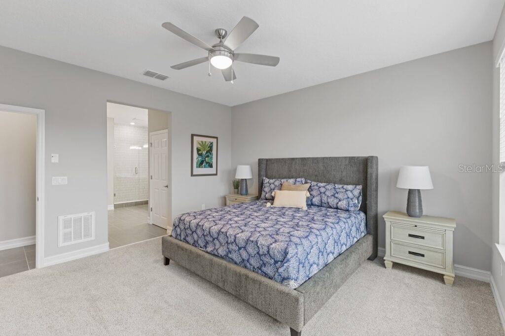 5567 Northwest 45th Lane Ocala, FL 34482 - Photo 14 of 21 a bedroom with a bed and a lamp on dresser