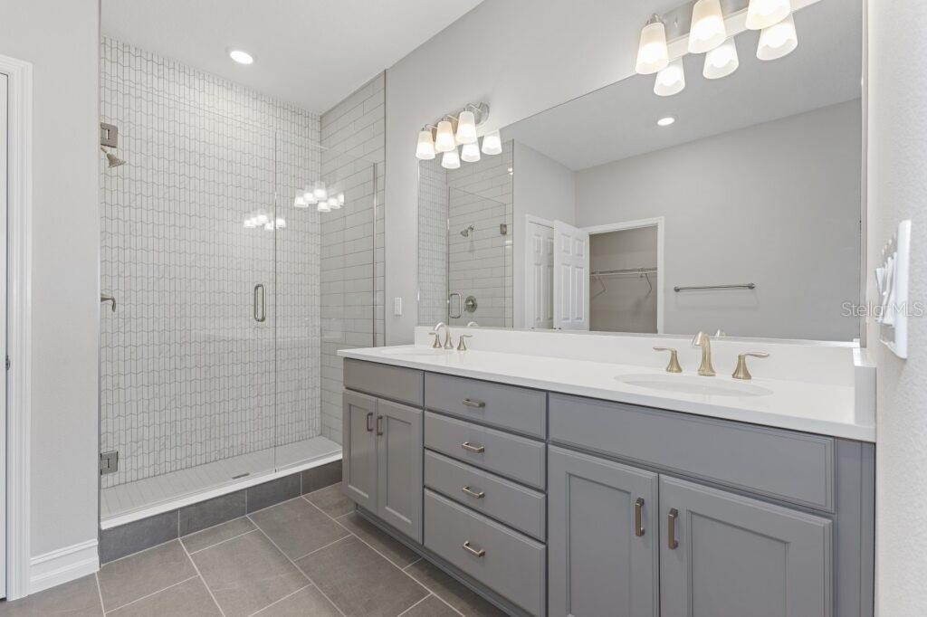 5567 Northwest 45th Lane Ocala, FL 34482 - Photo 16 of 21 a bathroom with a double vanity sink mirror and shower