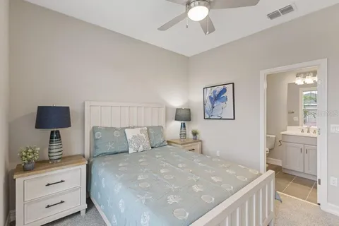 a bedroom with a bed and a chandelier