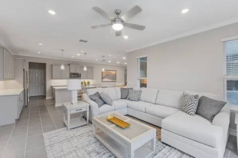 a living room with furniture and a chandelier