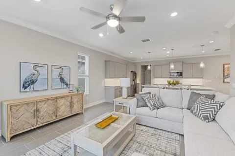 a living room with furniture and kitchen view