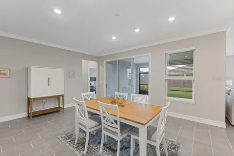 a dining room with furniture and window