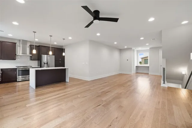 a view of a kitchen with a sink and wooden floor