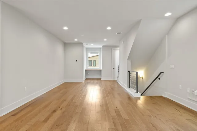 a view of an entryway with wooden floor and door