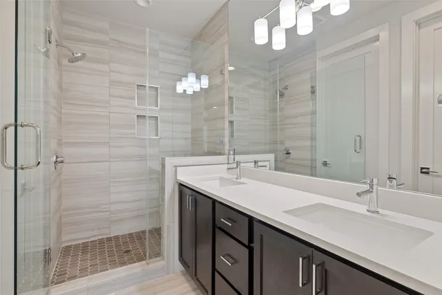 a bathroom with a sink a shower and a mirror