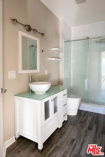 a bathroom with a sink a toilet and shower