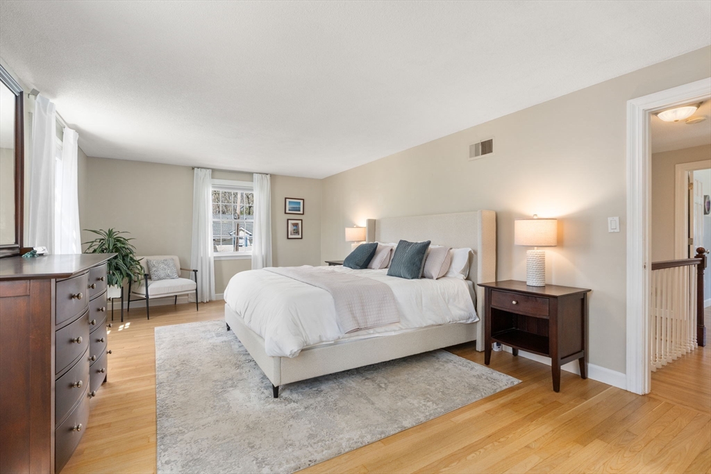 30 Ivy Road Wellesley, MA 02482 - Photo 18 of 34 a bedroom with a bed a table and a painting