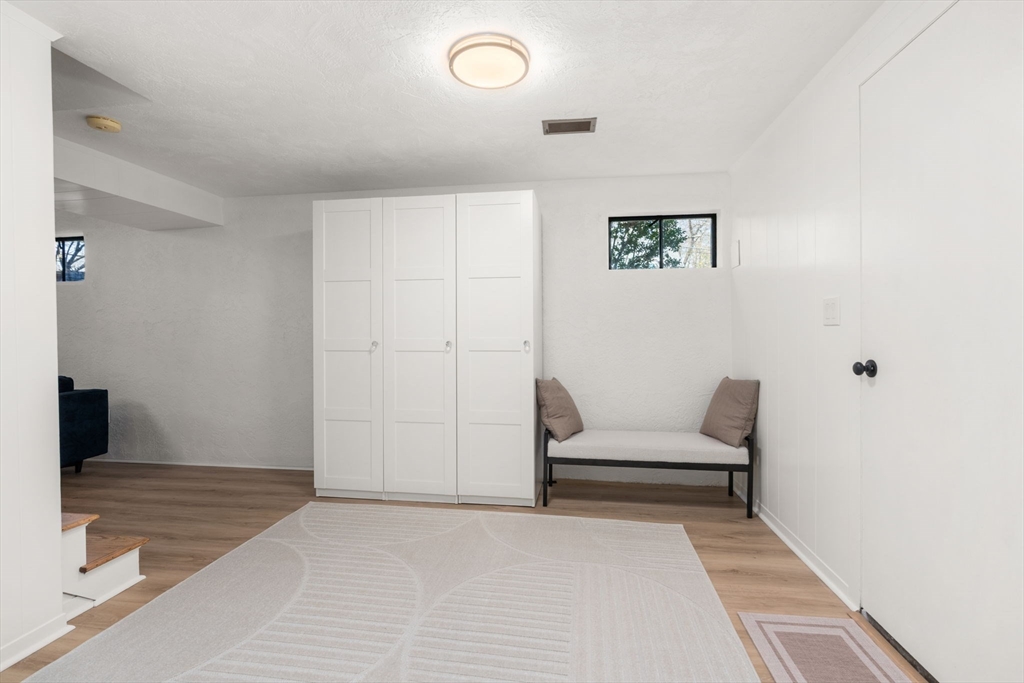 30 Ivy Road Wellesley, MA 02482 - Photo 28 of 34 a bedroom with a bed and white walls
