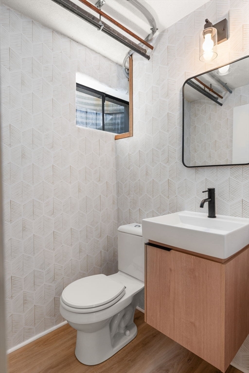 30 Ivy Road Wellesley, MA 02482 - Photo 29 of 34 a bathroom with a toilet a sink and mirror