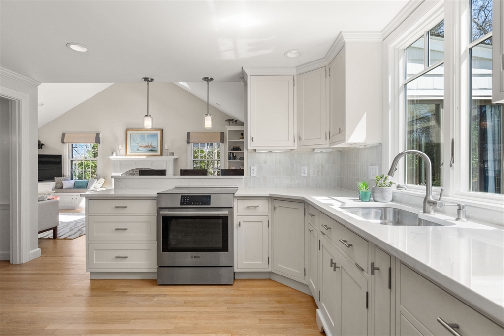 30 Ivy Road Wellesley, MA 02482 - Photo 5 of 34 a kitchen with stainless steel appliances granite countertop a sink cabinets and a wooden floor