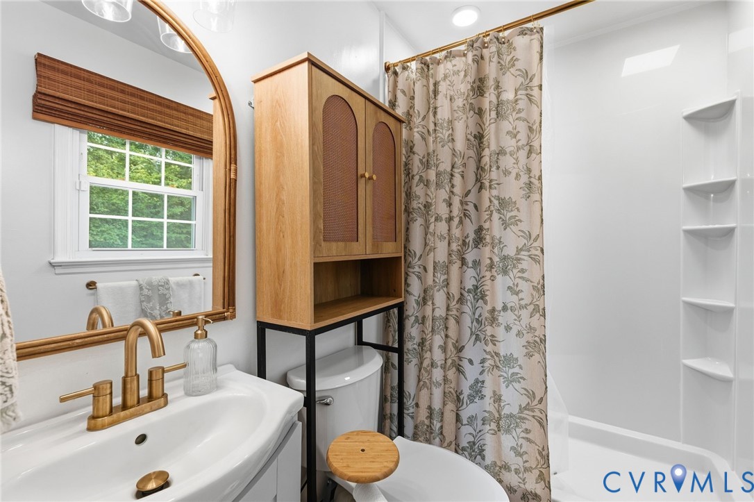 6723 Cherry Road Quinton, VA 23141 - Photo 13 of 28 Single sink vanity with brass-finish faucet, frame
