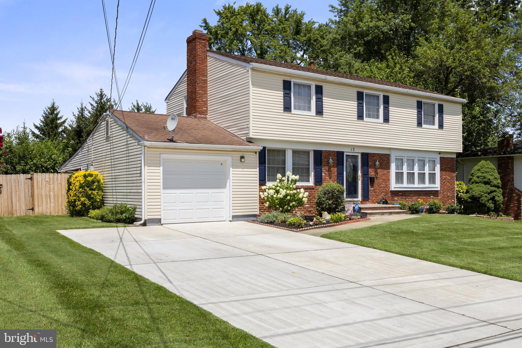 13 Rutgers Drive Delran, NJ 08075 - Photo 2 of 38 a front view of a house with a yard and garage