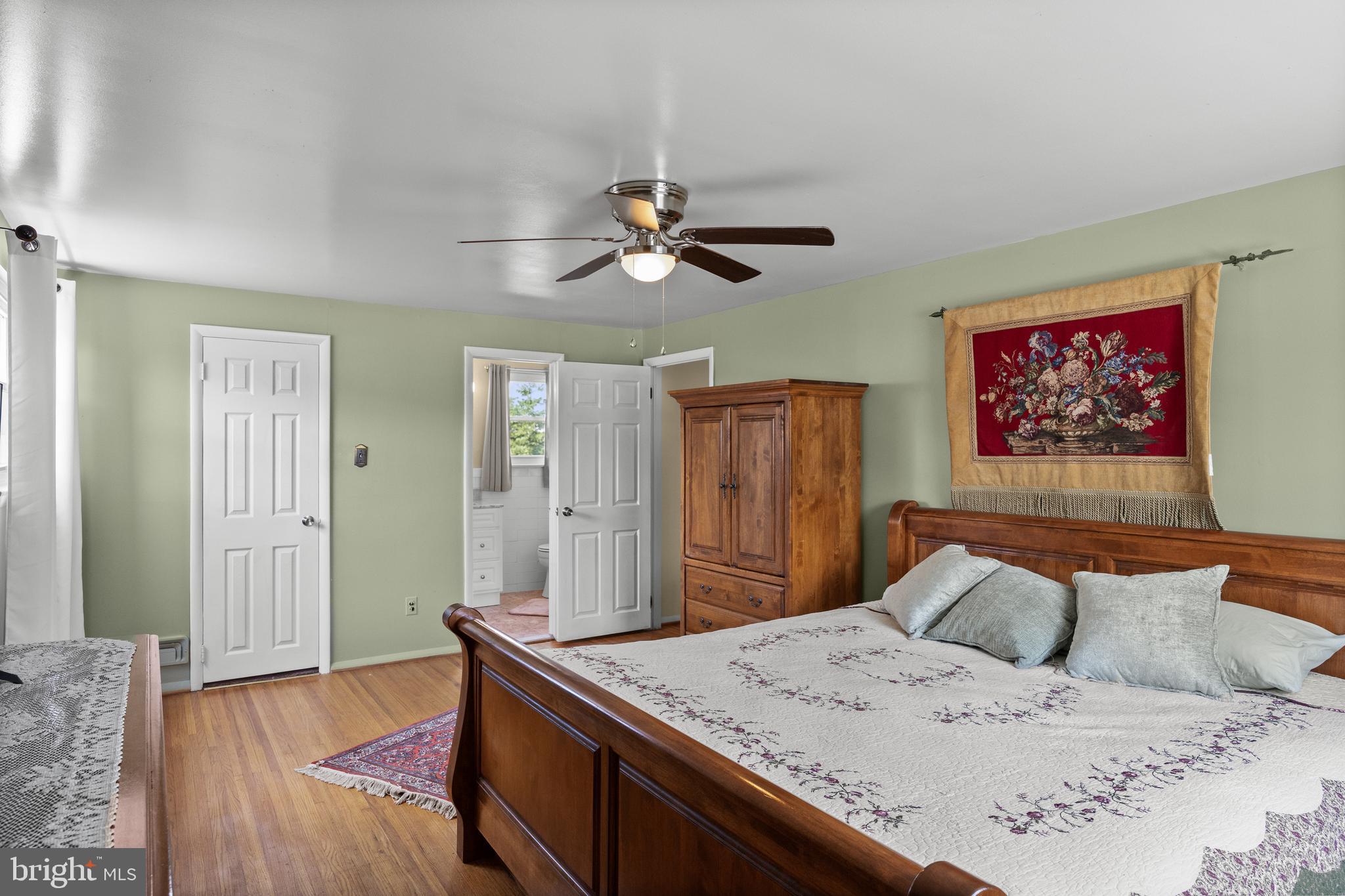13 Rutgers Drive Delran, NJ 08075 - Photo 21 of 38 a living room with a bed and a chandelier