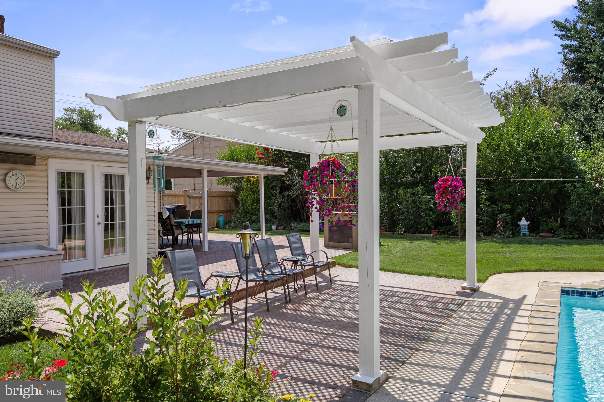13 Rutgers Drive Delran, NJ 08075 - Photo 4 of 38 a view of a patio with table and chairs potted plants and floor to ceiling window