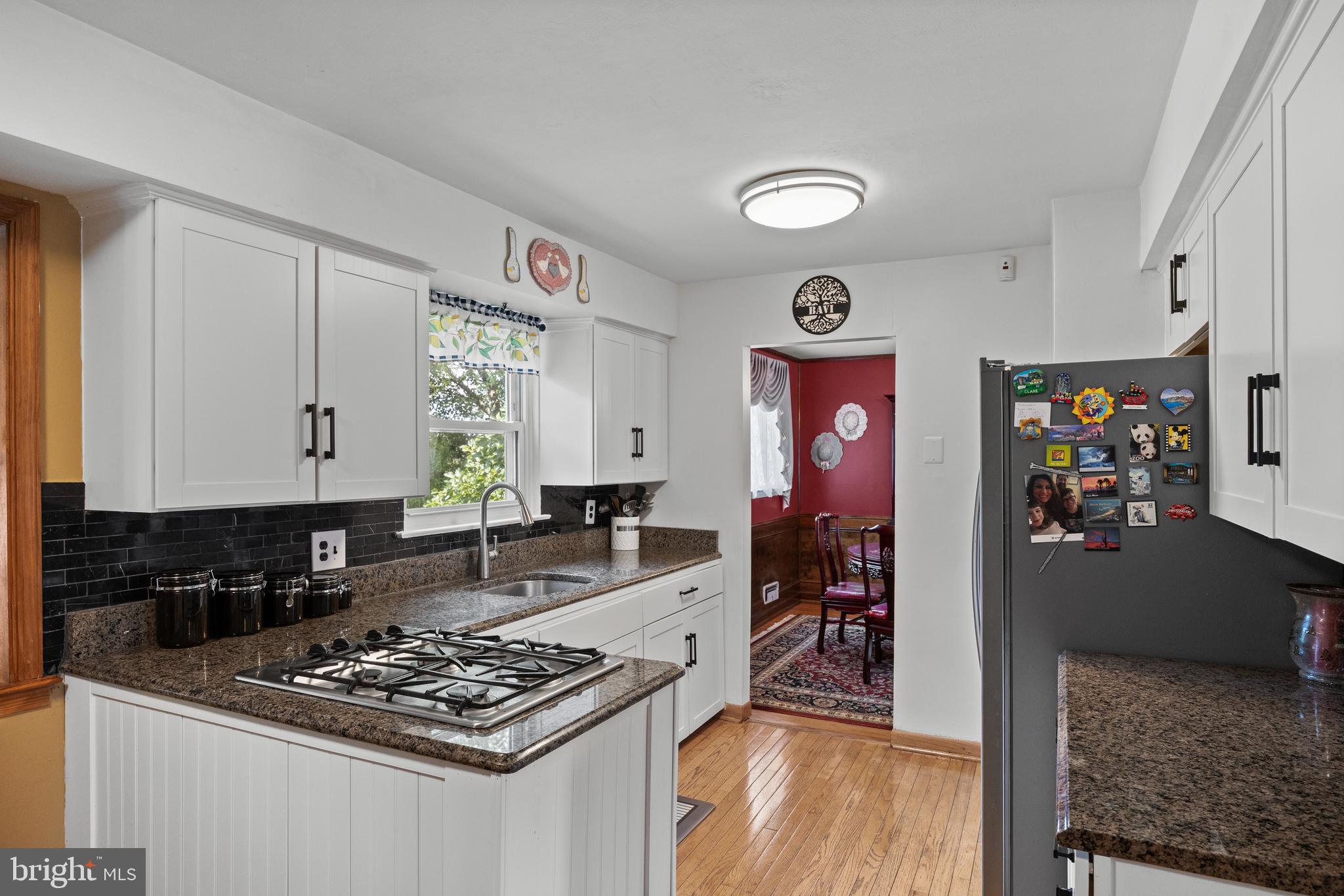 13 Rutgers Drive Delran, NJ 08075 - Photo 9 of 38 a kitchen with stainless steel appliances granite countertop a stove top oven a sink dishwasher and cabinets with wooden floor
