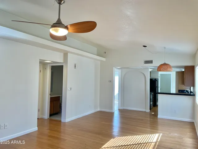 a view of a room with wooden floor and chandelier
