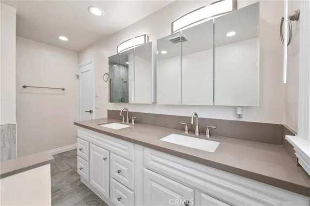 a bathroom with a double vanity sink and mirror