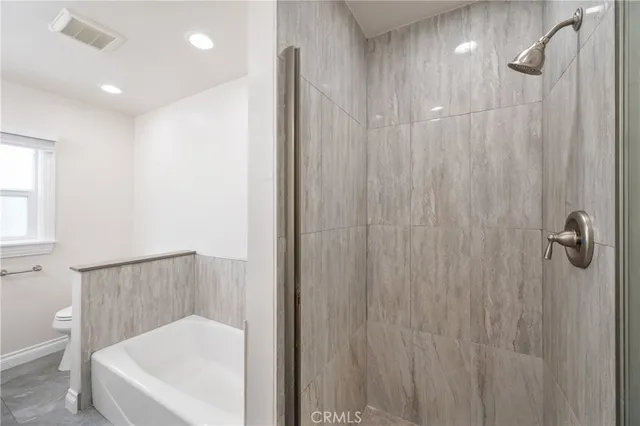 a bathroom with a shower and a bath tub