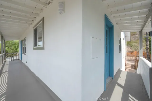 a view of a hallway to a livingroom with furniture