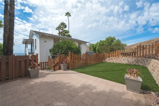a view of a chairs and table in backyard