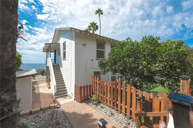 a view of a house with wooden fence