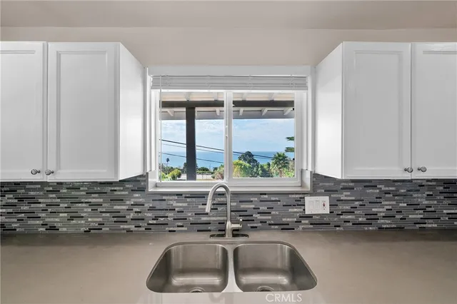 a kitchen with a sink and a window