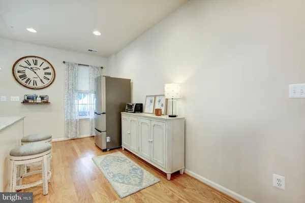 a kitchen with a refrigerator a microwave a stove and white cabinets