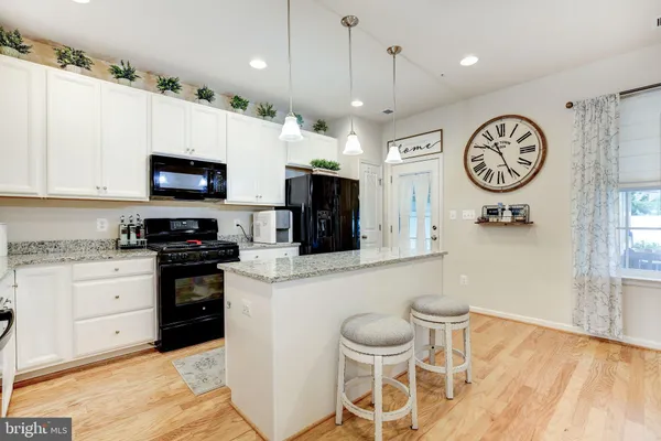 a kitchen with a sink a microwave a stove and refrigerator