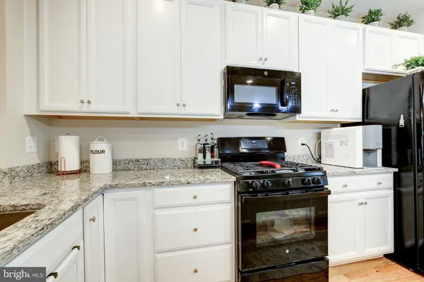 a kitchen with wooden cabinets and a stove top oven