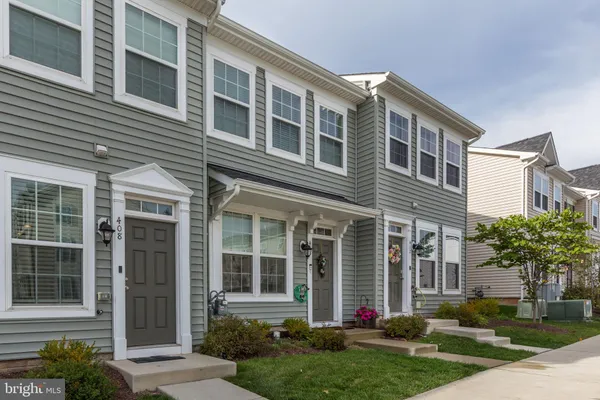 a front view of a house with a potted plant