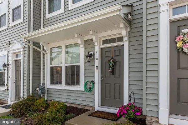 a front view of a house with yard and green space