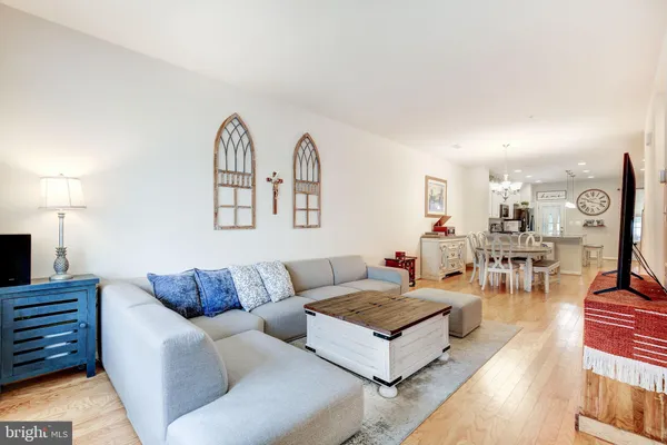 a living room with furniture and a view of kitchen