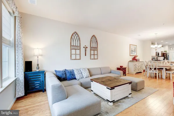 a view of a hallway with wooden floor and closet