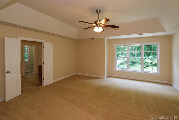 7131 Forest Ridge Road Weddington, NC 28104 - Photo 16 of 23 an empty room with windows and fan