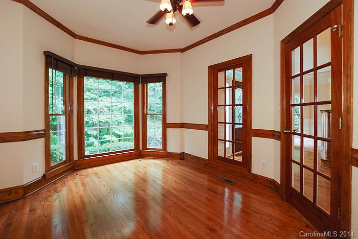7131 Forest Ridge Road Weddington, NC 28104 - Photo 7 of 23 a view of an empty room with wooden floor and a window