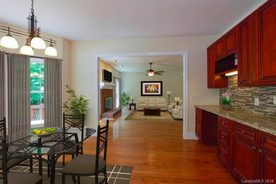 7131 Forest Ridge Road Weddington, NC 28104 - Photo 8 of 23 a kitchen with sink refrigerator dining table and chairs